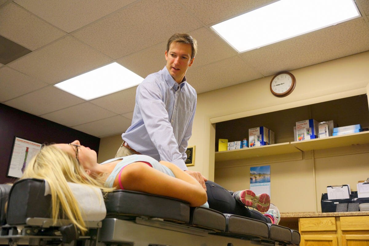 Dr. Reinhardt adjusting a patient in a treatment room